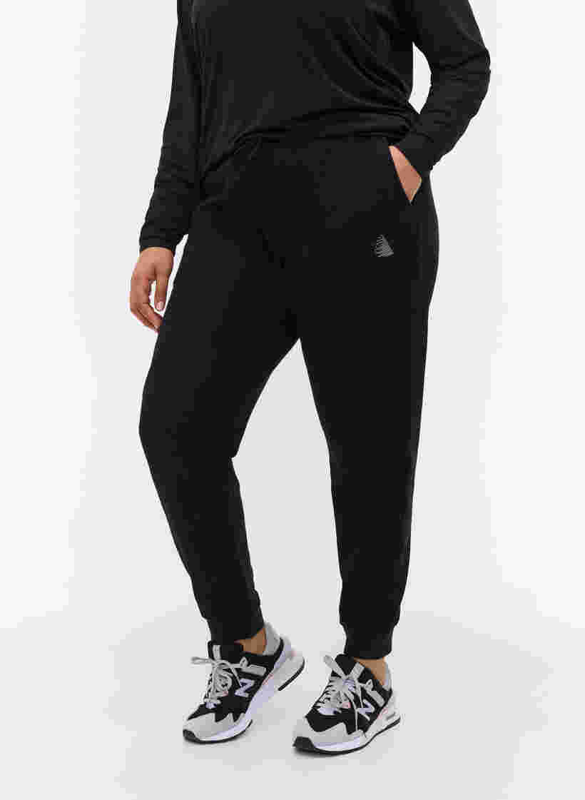 Enfärgade träningsbyxor med fickor, Black, Model image number 2