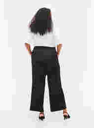 Byxor i lös passform med fickor och resårkant, Black, Model