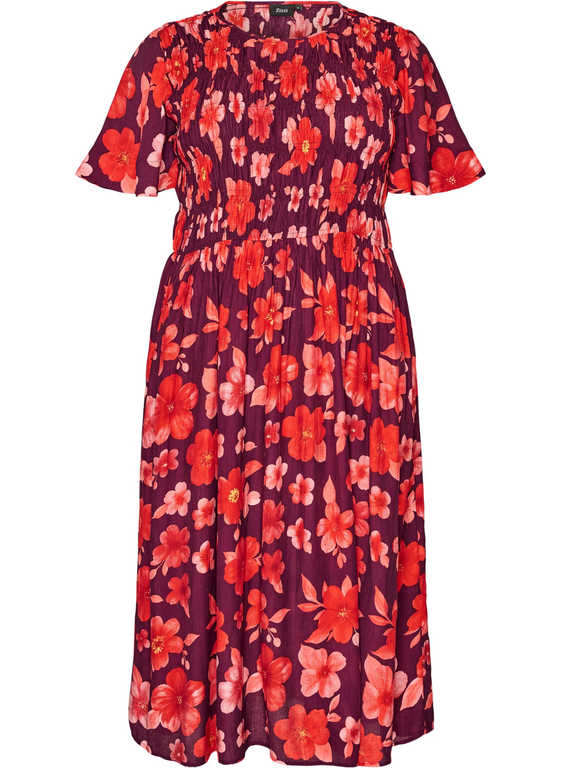 Kl&auml;nning med smock och blommigt m&ouml;nster