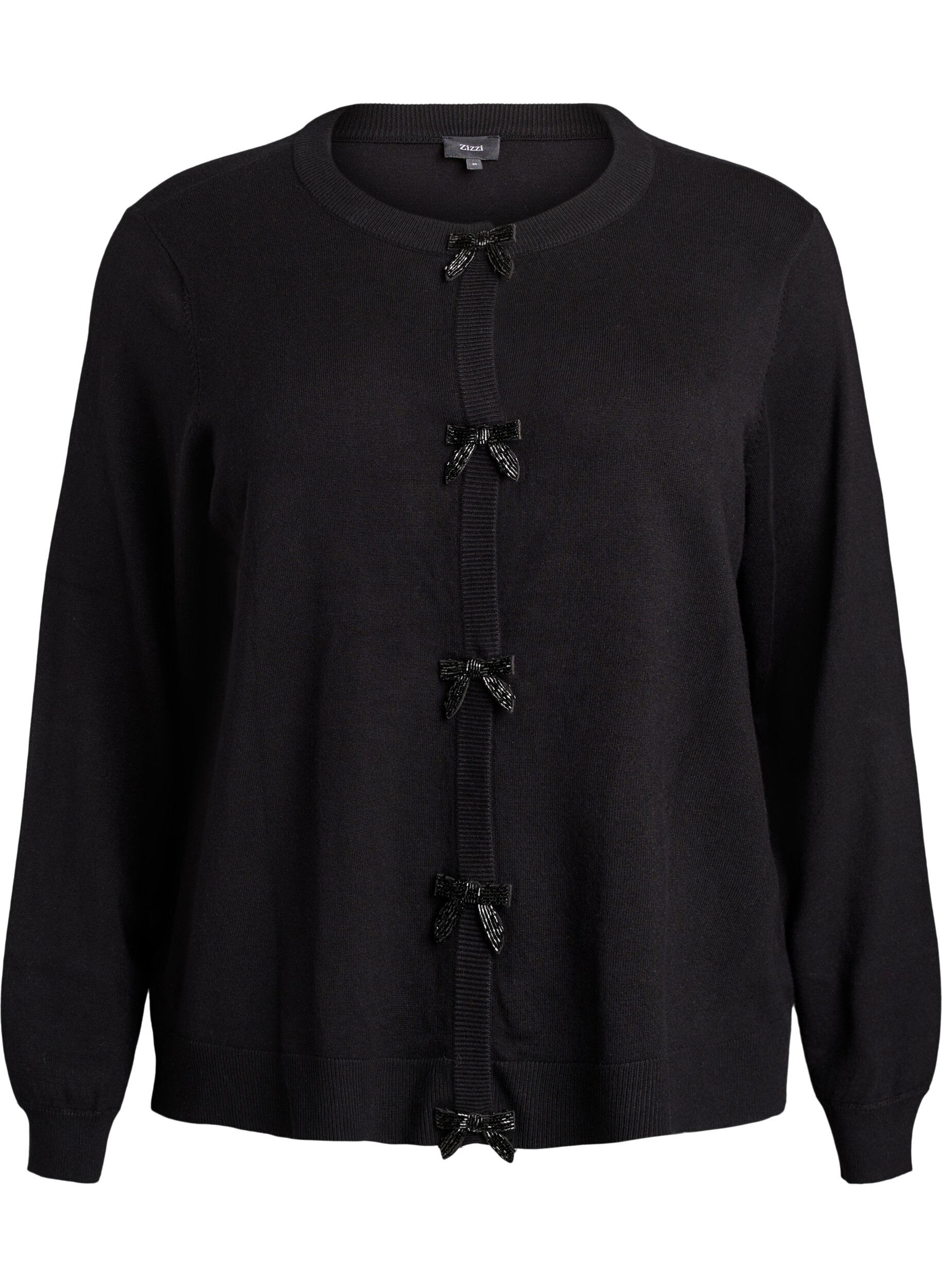 Kofta med p&auml;rlbroderade rosetter och tryckknappar