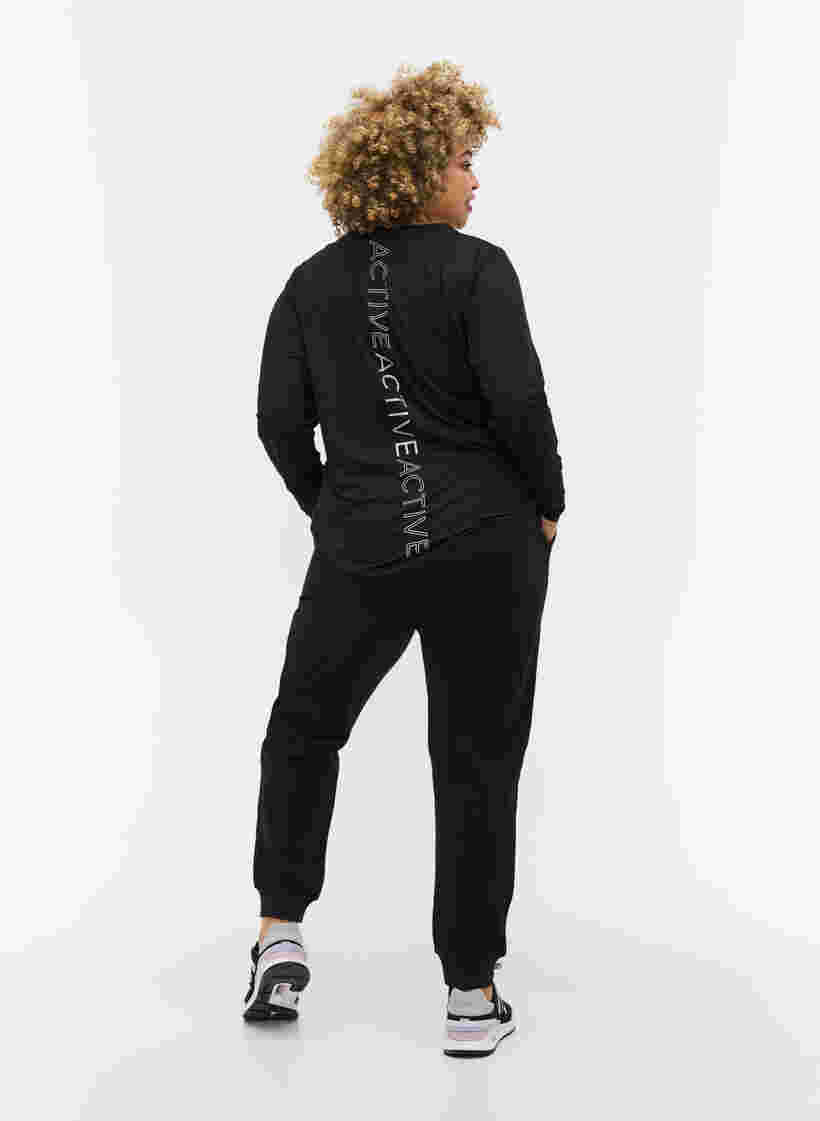 Enfärgade träningsbyxor med fickor, Black, Model image number 1