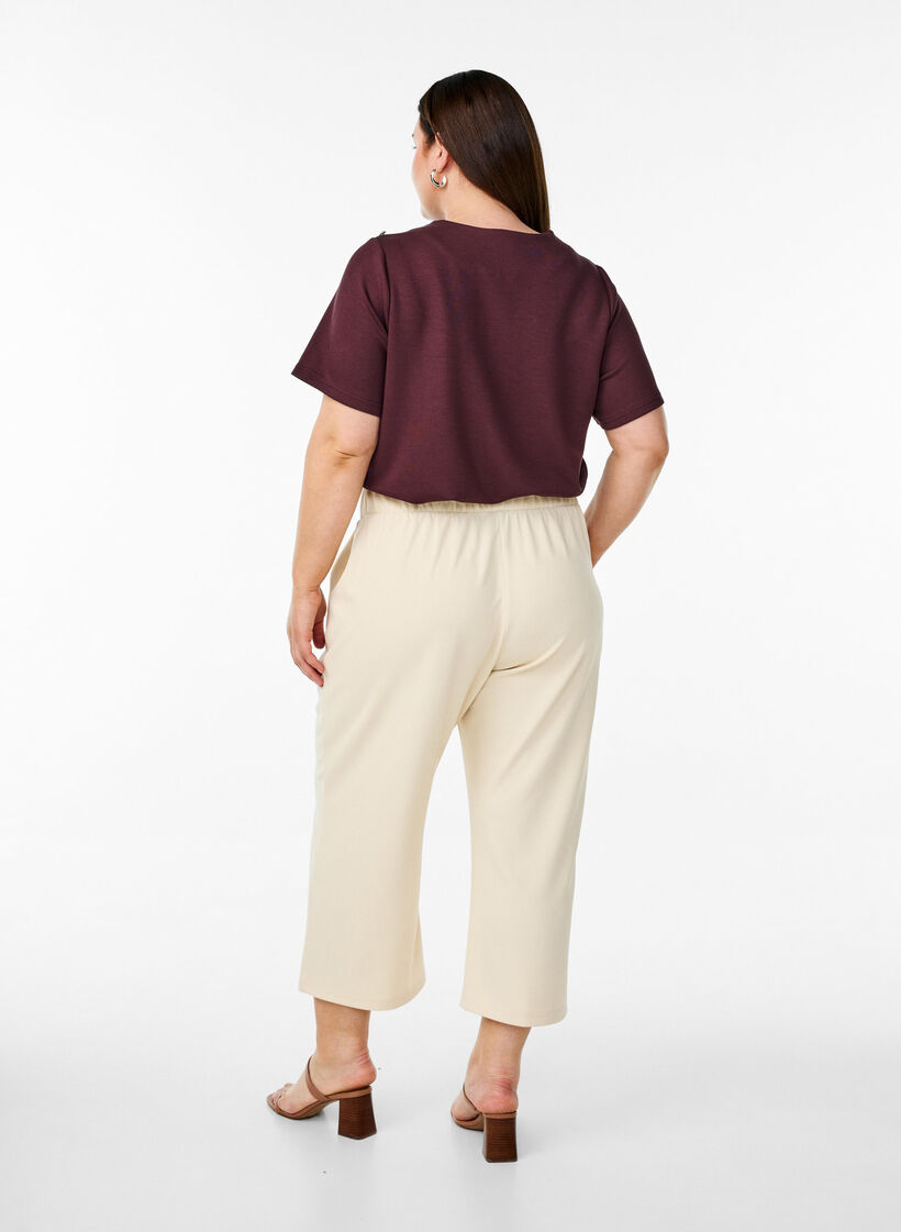 Byxor med l&ouml;s passform och 7/8-l&auml;ngd, Beige, Model image number 1